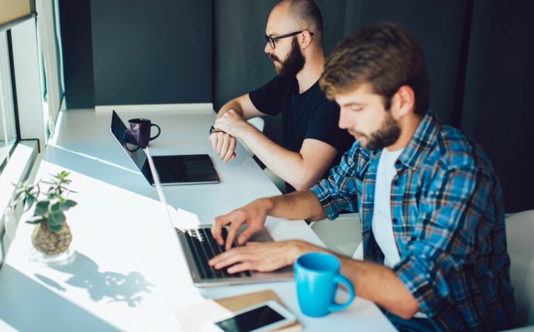 millennial men using digital technology for developing software