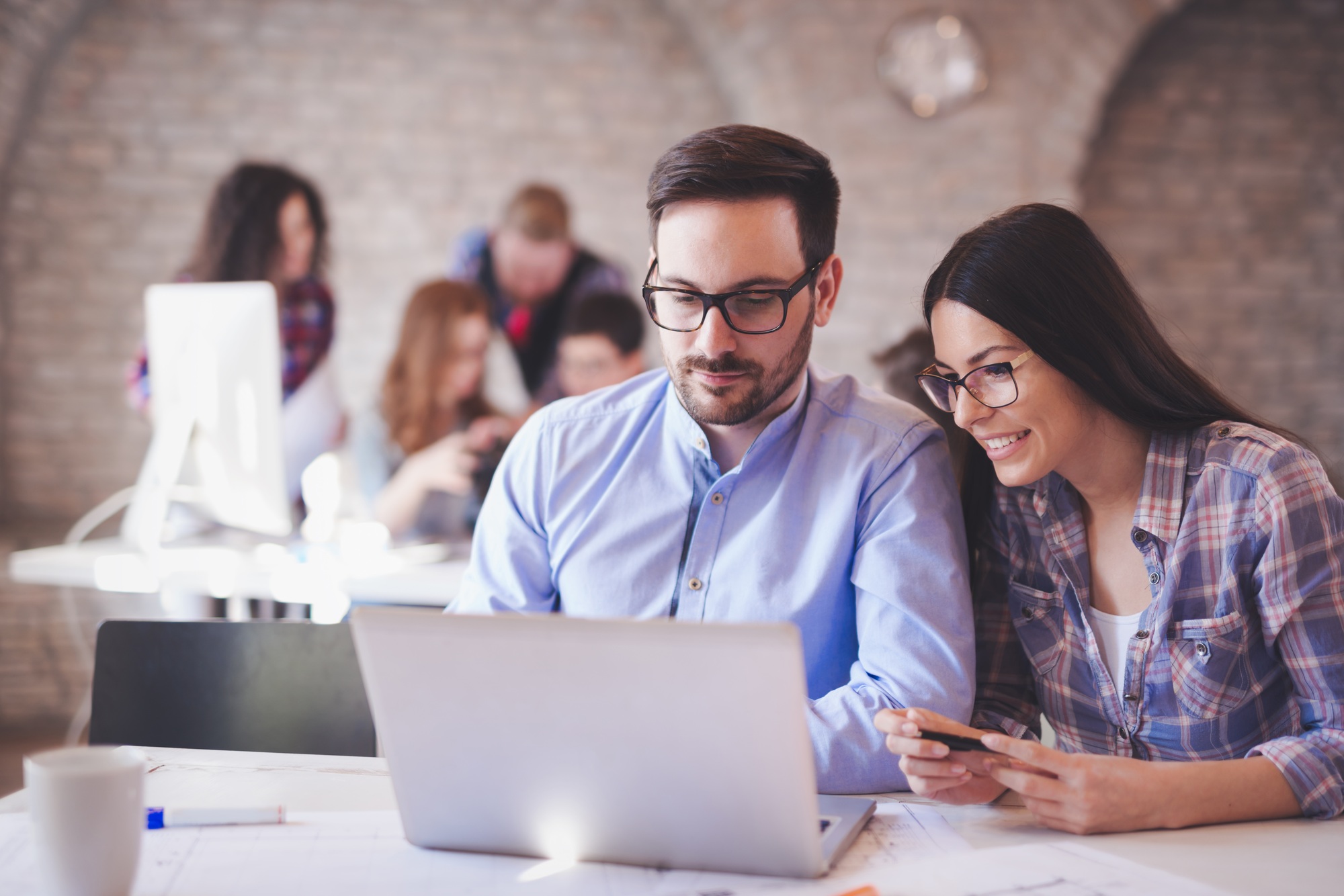 Programmers cooperating at information technology company